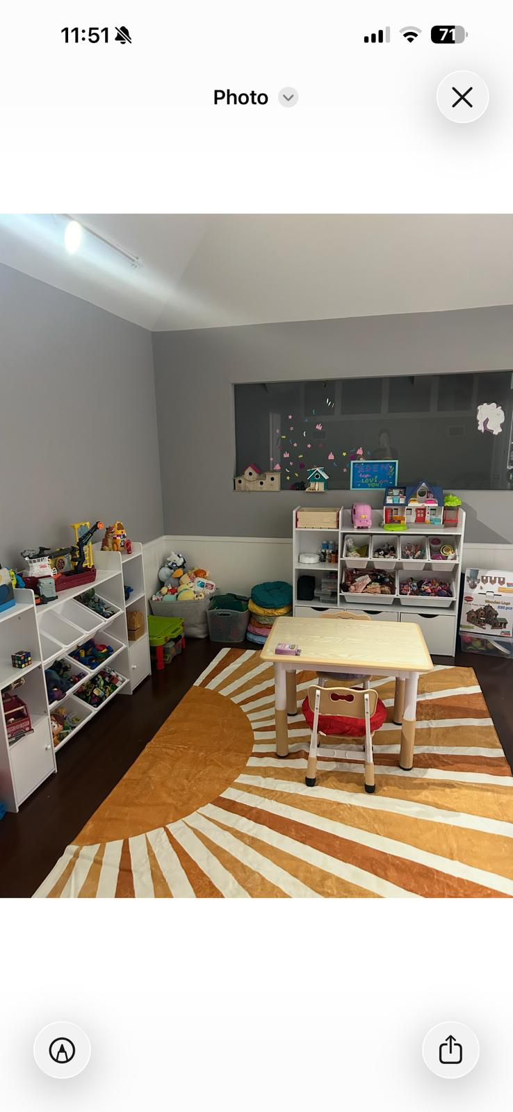 An organized playroom with toys sorted into accessible shelves